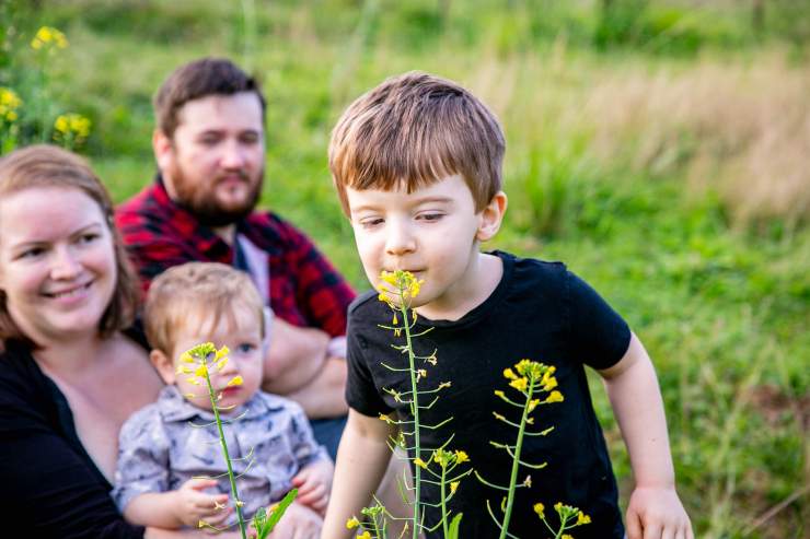 child smelling flower