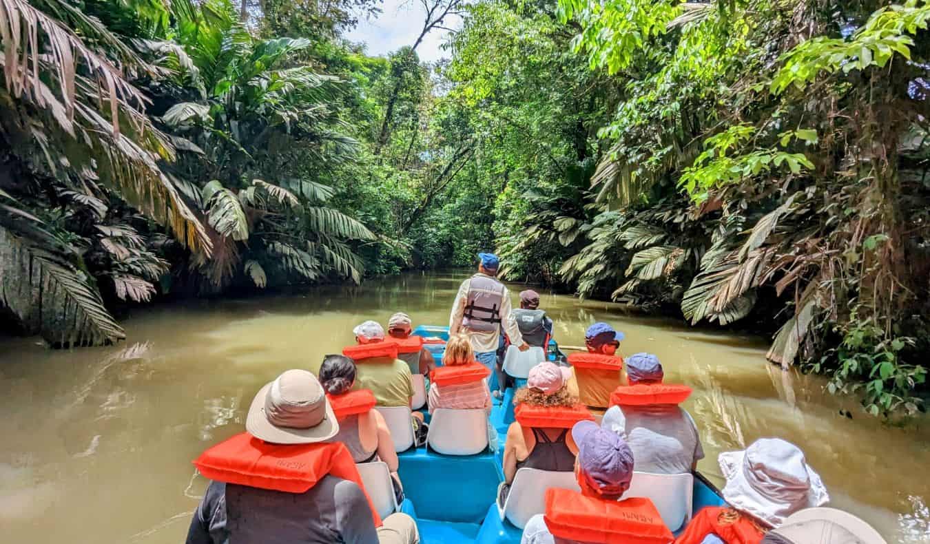 a TNN group tour costing down a narrow river in the jungle