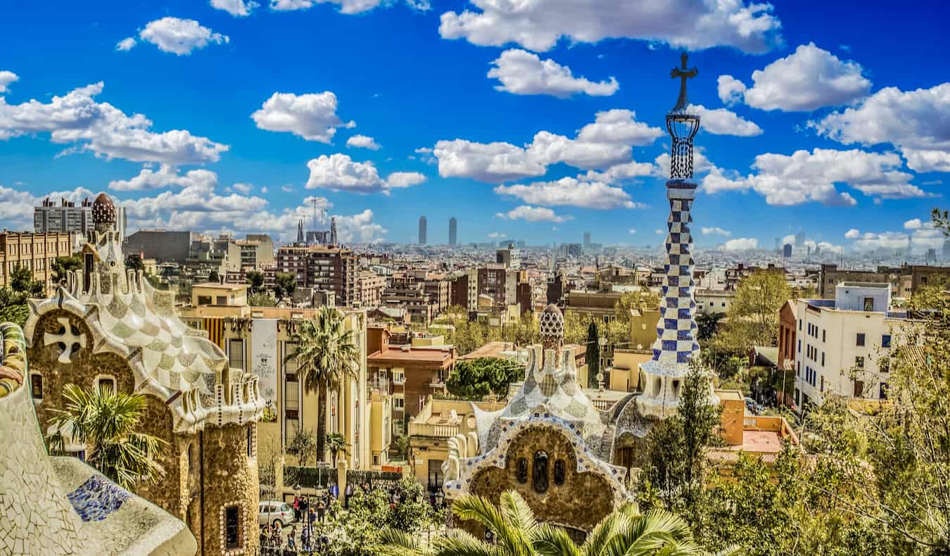 A blue sky over Park Guell in sunny Barcelona, Spain with the city skyline the background